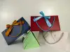 Solid color bow creative gift bags, hand-held triangular bag paper bags, 300g white card paper bags, cross-border exclusive supply details Picture